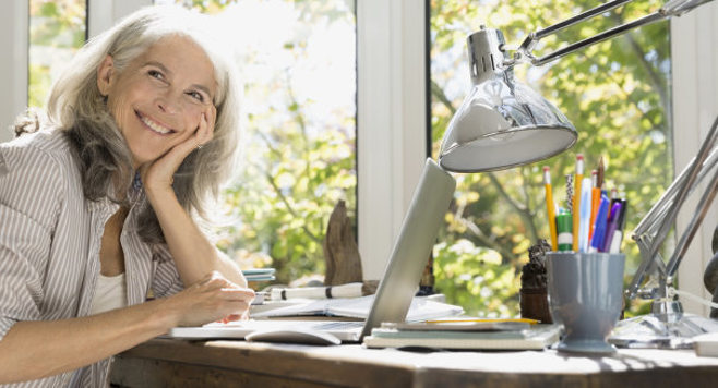 Woman smiling in her home office.
